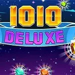 Hlavný nápis „1010 DELUXE“ na farebnom pozadí s rôznymi farebnými drahokamami okolo