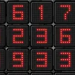 Čierne pozadie s maticou červených LED číslic, zobrazujúcich rôzne čísla