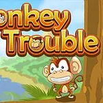 Ilustrácia usmievajúcej sa opičky pod logom Monkey in Trouble na pozadí tropickej krajiny