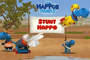 Animovaný modrý hroch v superhrdinskej maske vyskakujúci z dela popri ďalších hrochoch, pozadí tvorí púštna krajina so stromami a transparentom s textom Stunt Happo