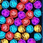 Farebné tekvicové hlavy v rôznych výrazoch a farbách, vrátane fialovej, červenej, modrej a žltej, usporiadané na čiernom pozadí